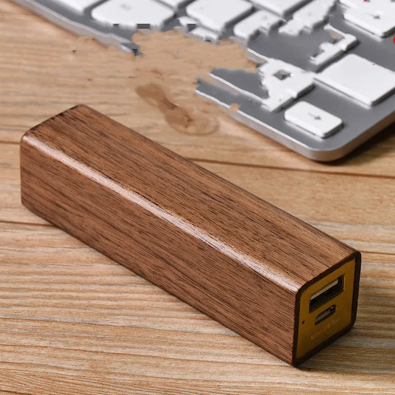 Brown walnut wood portable power bank showing its rectangular shape and natural wood grain.