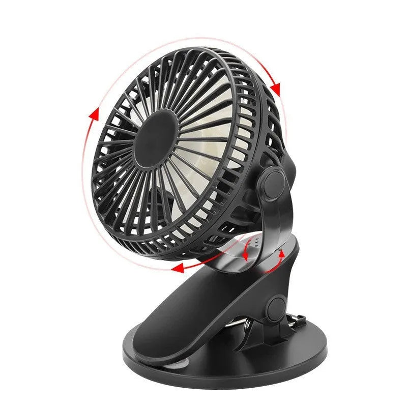 Small white clip fan with USB cable attached to a desk edge