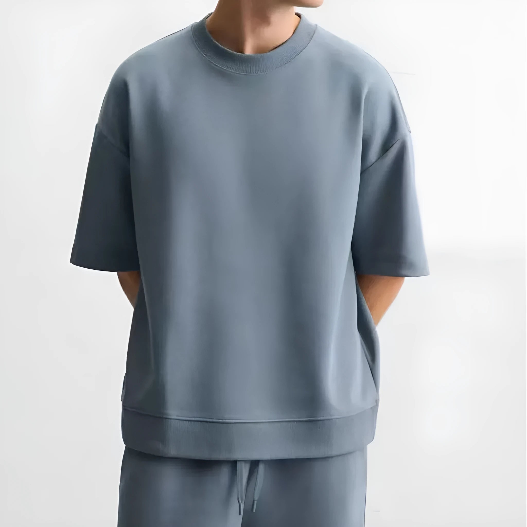 Loose blue polyester T-shirt and matching shorts set on a hanger, showing round neck and double-sided texture.