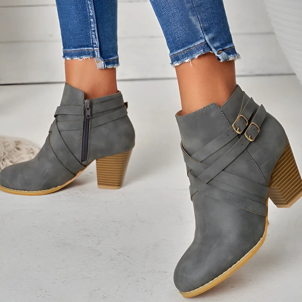 Women's grey PU leather ankle boot with a 7cm heel, side zipper, and belt buckle.