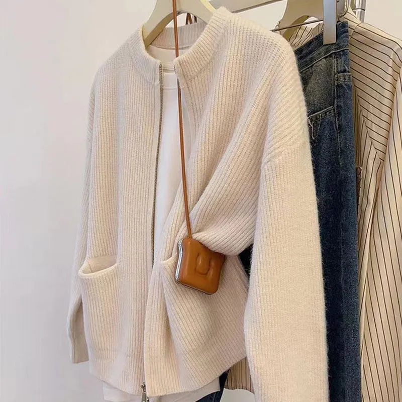 Beige viscose knit long sleeve cardigan sweater coat on a hanger
