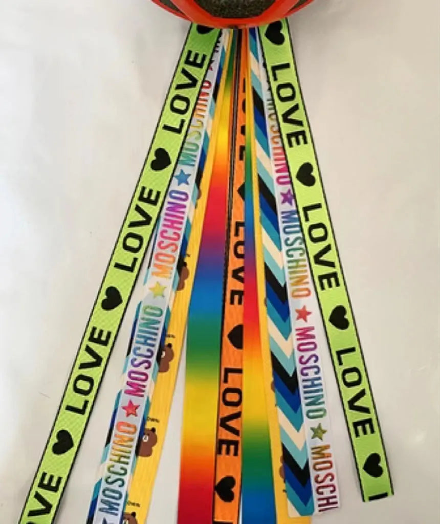 A colourful helmet streamer accessory for children's sports helmets and doll decoration.