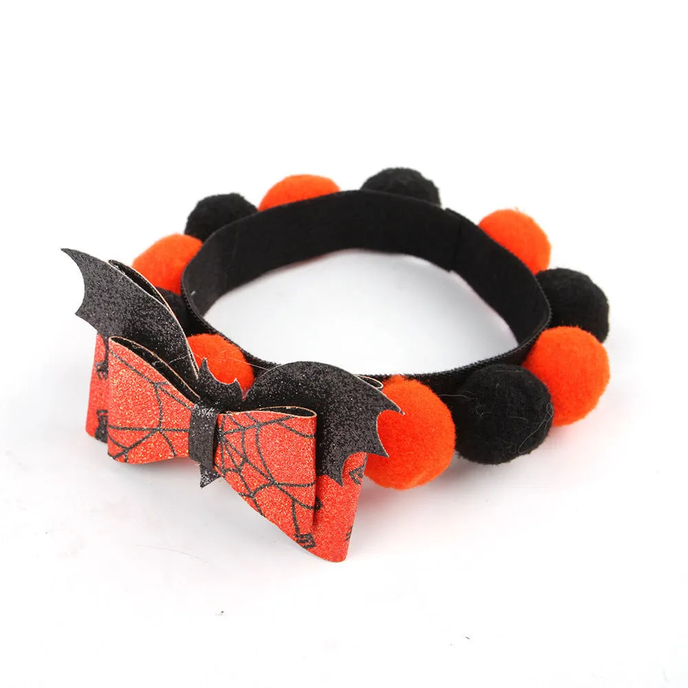 Halloween pet collar with soft fur ball pumpkin accessory in orange, sized on a dog's neck.