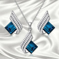 Electroplated alloy necklace and earring set with glass pendant and cross chain design