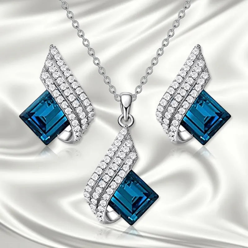 Electroplated alloy necklace and earring set with glass pendant and cross chain design