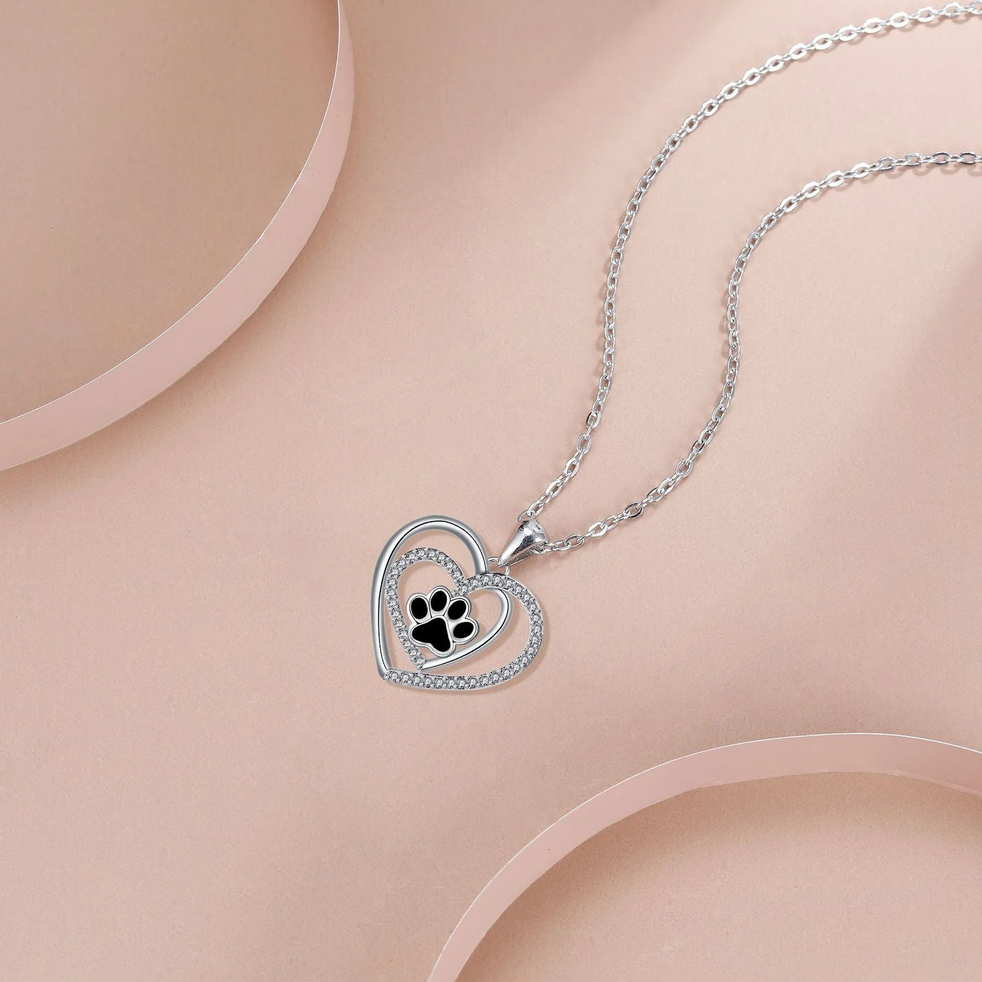 Dog paw print necklace with heart-shaped pendant on cross chain for women