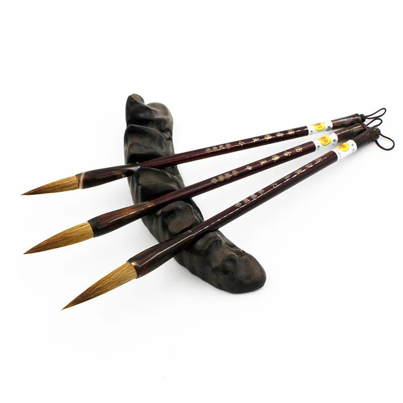 Traditional Chinese wolf hair calligraphy brush with steel rod, shown in large, medium, and small sizes.