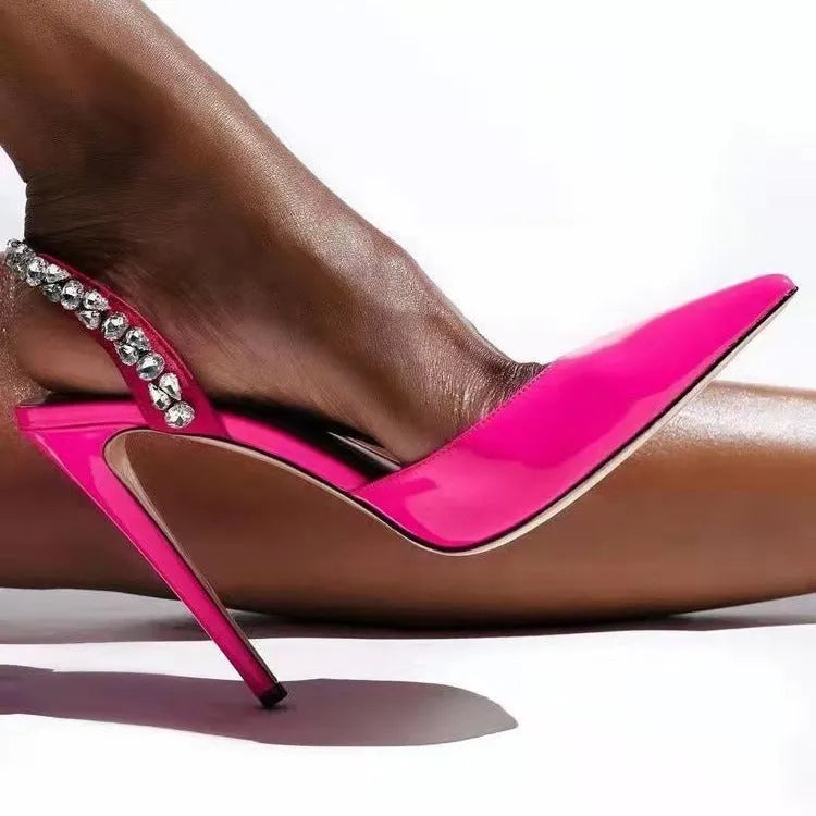 Pointed toe high heel sandals with rhinestone detail on the side, shown in patent leather.