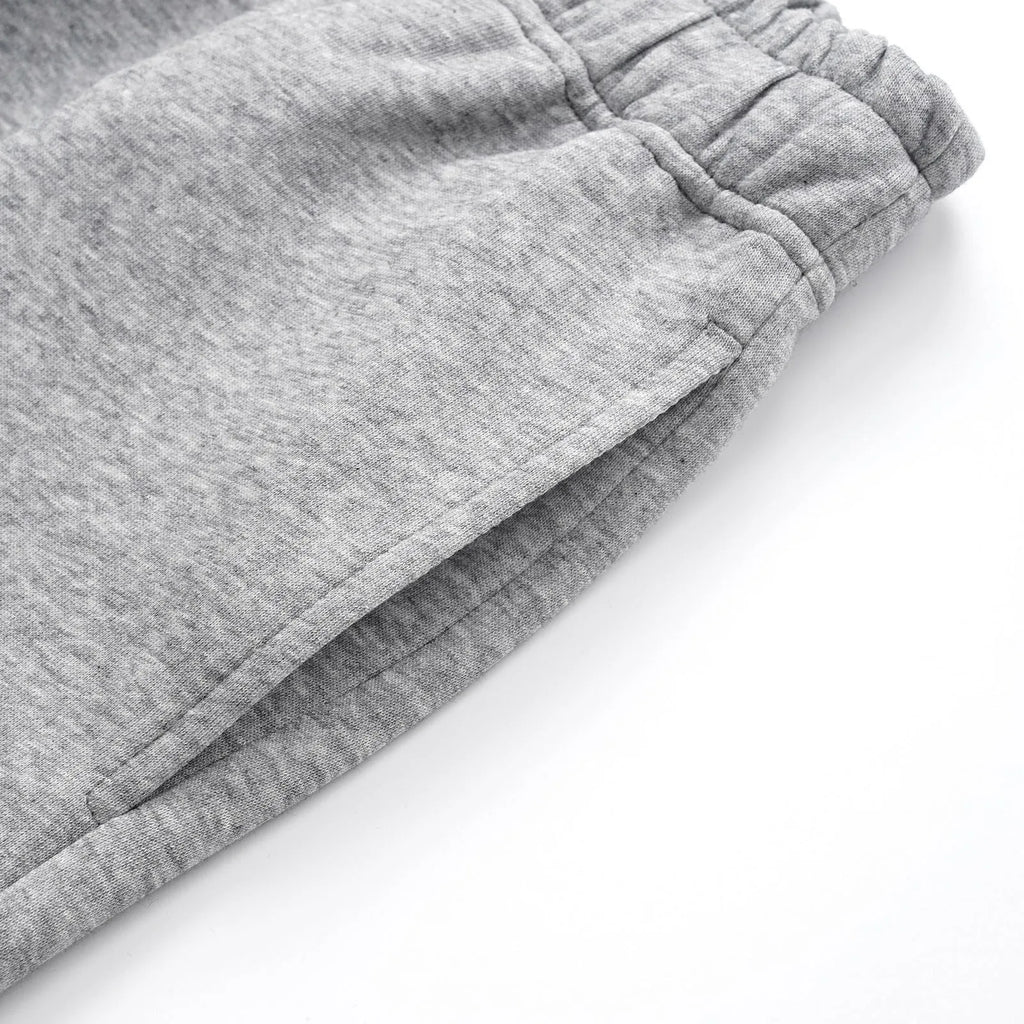 Men's straight-leg cotton casual trousers in solid black colour showing mid-waist design