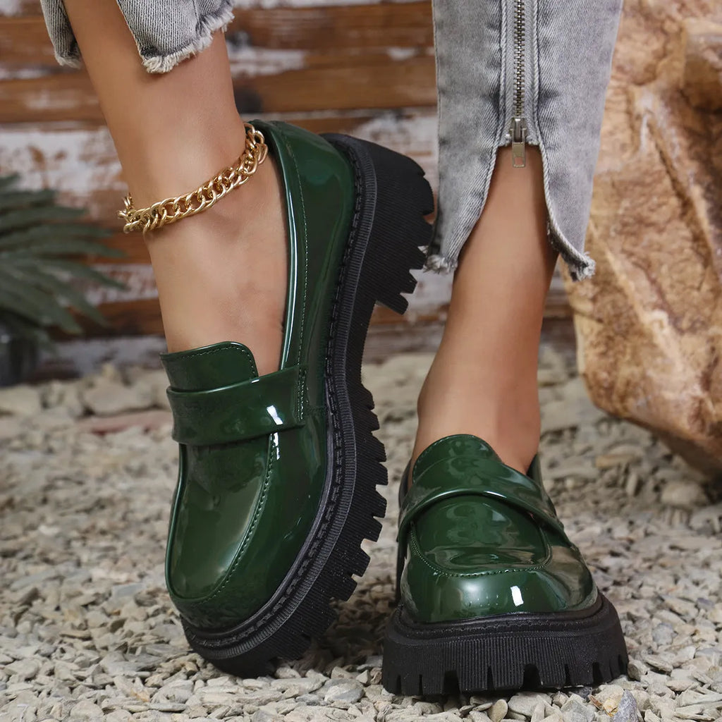 Plus size women's black slip-on loafers with a chunky mid-heel and thick rubber sole.