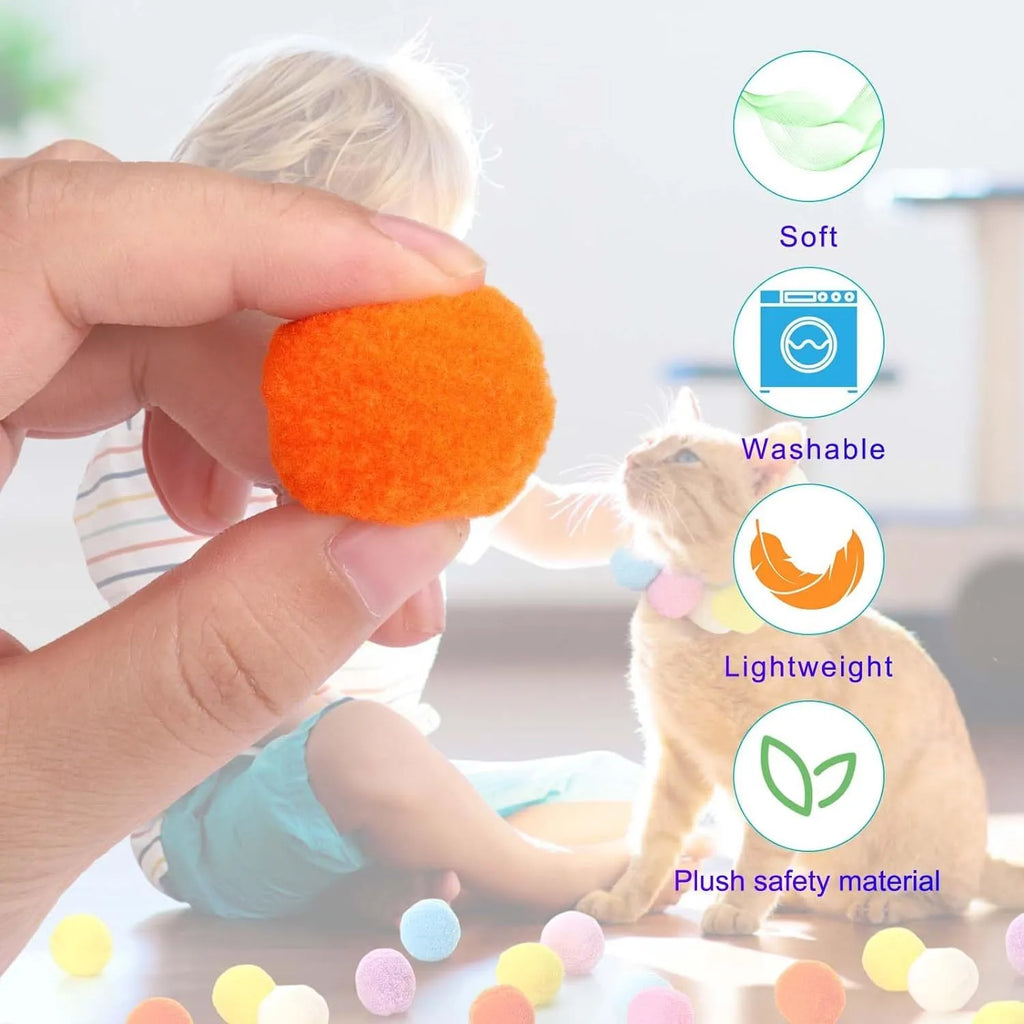 Cat toy ball launcher gun in hand with 20 soft plush pom pom balls for interactive fetch play
