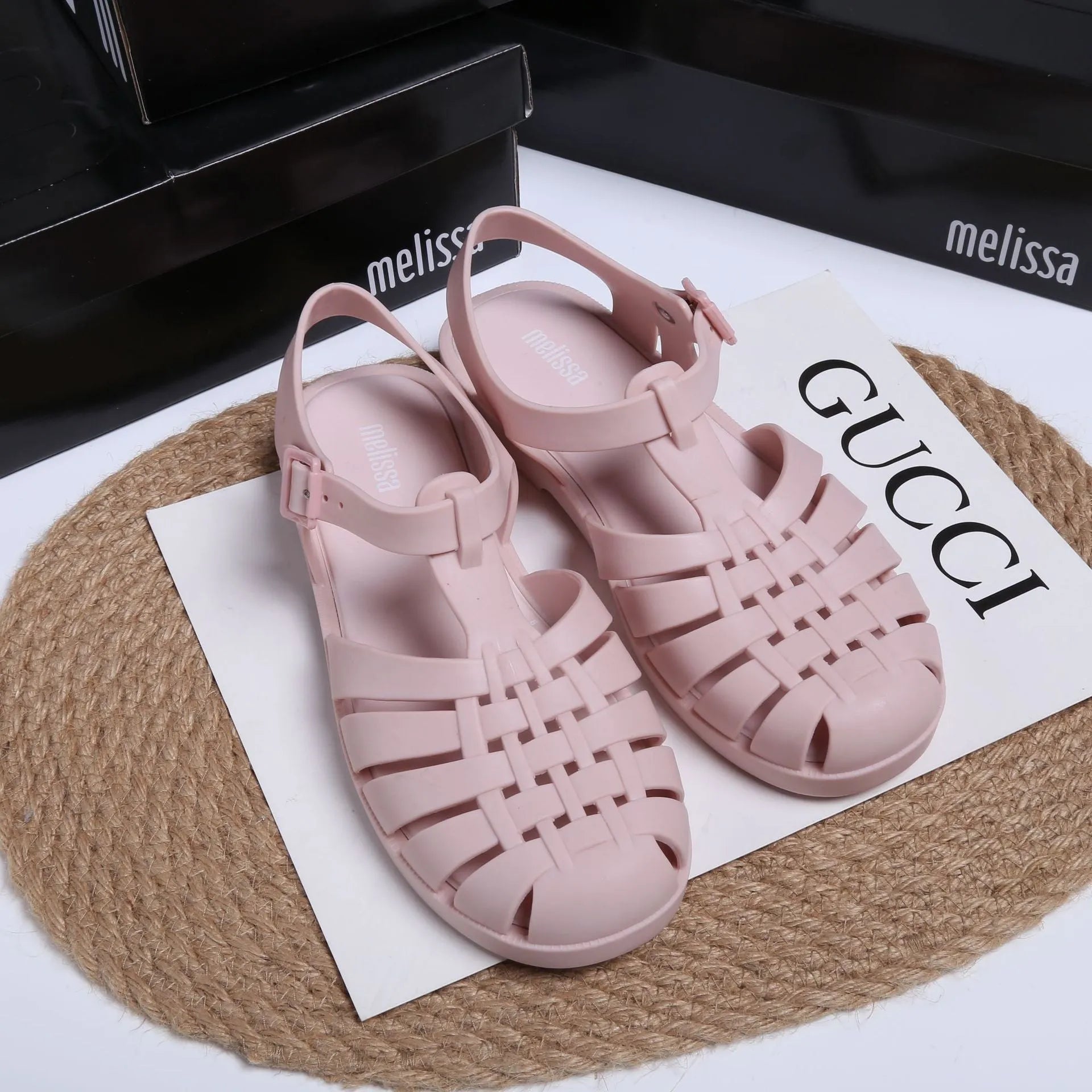 Matte black Roman sandals with vintage weave pattern and buckle closure