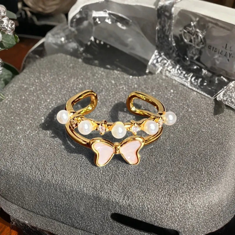 Adjustable Chinese gourd ring with zircon inlay showing floral and bow elements in oil-drip finish