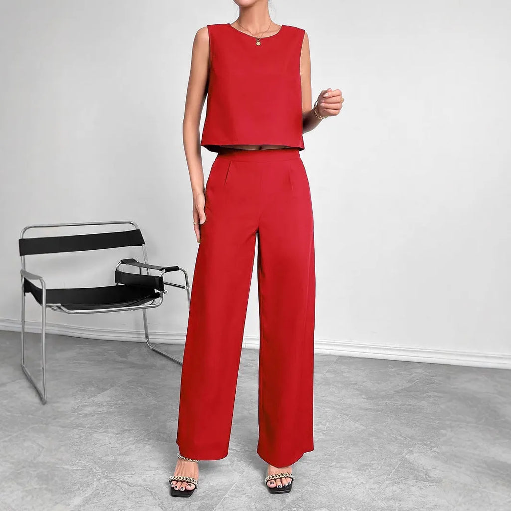 Women's red polyester two-piece set with sleeveless top and wide leg trousers on mannequin