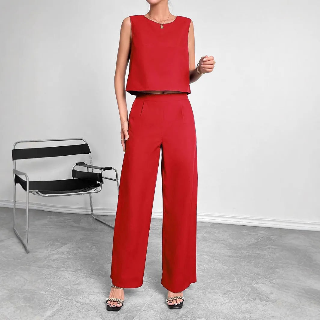 Women's red polyester two-piece set with sleeveless top and wide leg trousers on mannequin