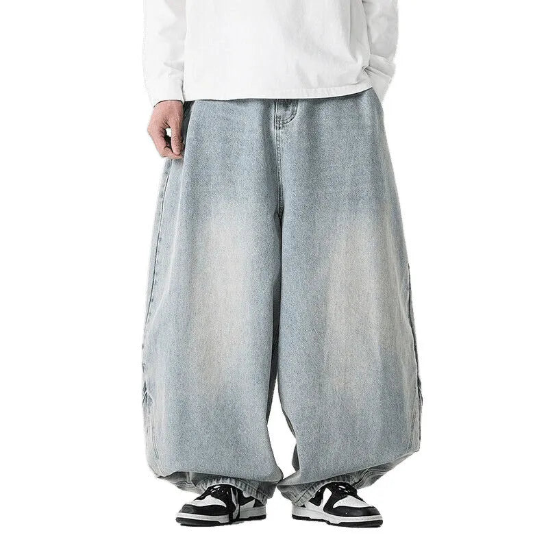 Men's plus size baggy wide leg jeans in light blue denim laid flat