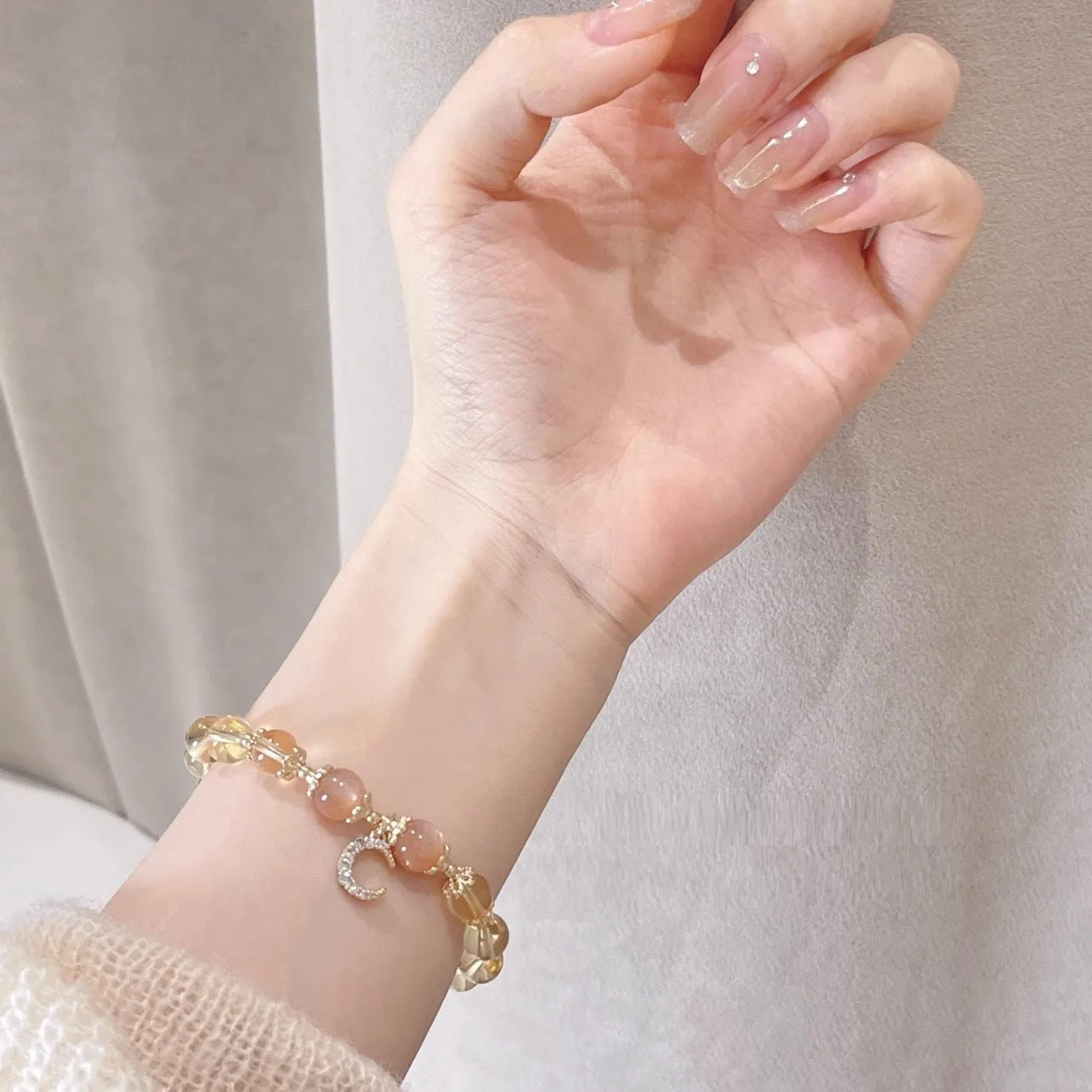 Chinese style crystal bracelet with diamond-shaped stones and gold electroplated finish.