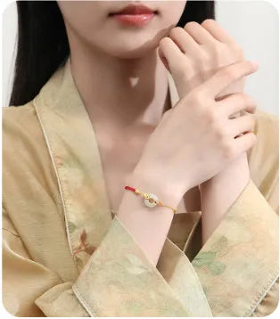 Women's koi peace buckle bracelet in 925 silver with electroplated gold finish on red rope
