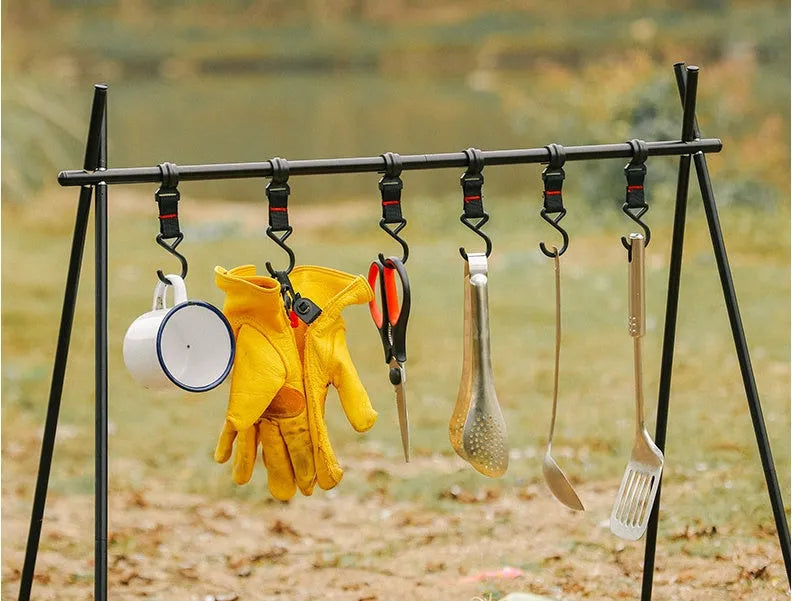 Silver aluminium foldable triangle camping clothes drying rack with side hanger and multiple hooks.