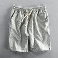 Man wearing black and white striped cotton casual shorts with a loose straight leg and elasticated waist.