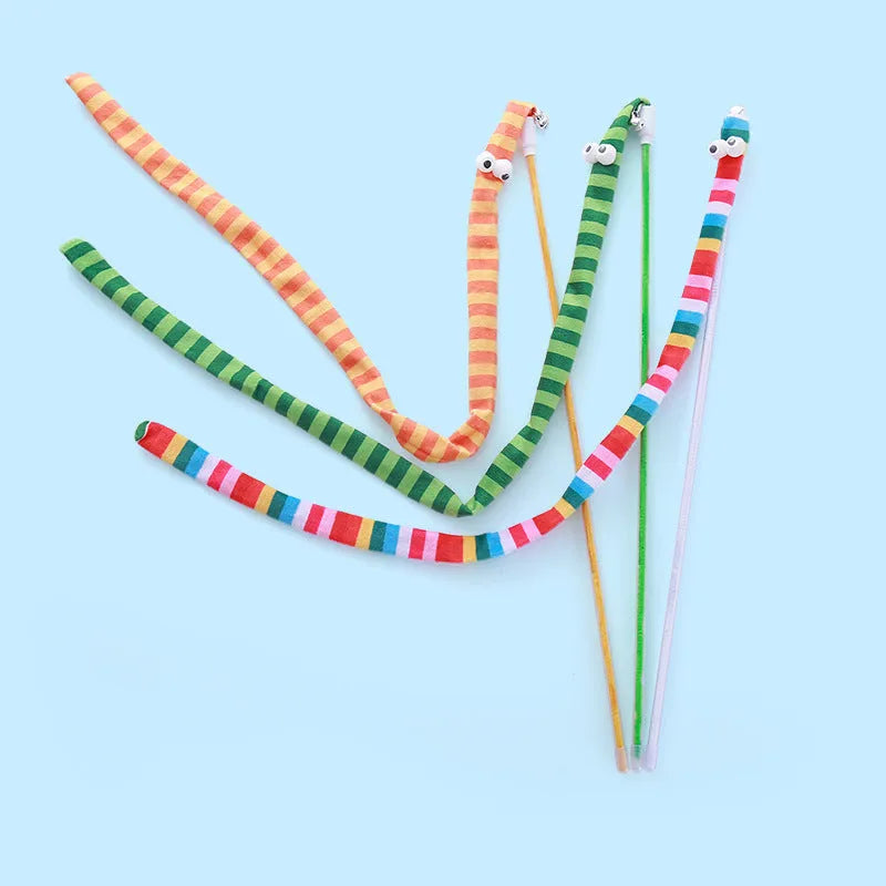 Colourful cat teaser wand with a long plush strip and a bell, held by a person.