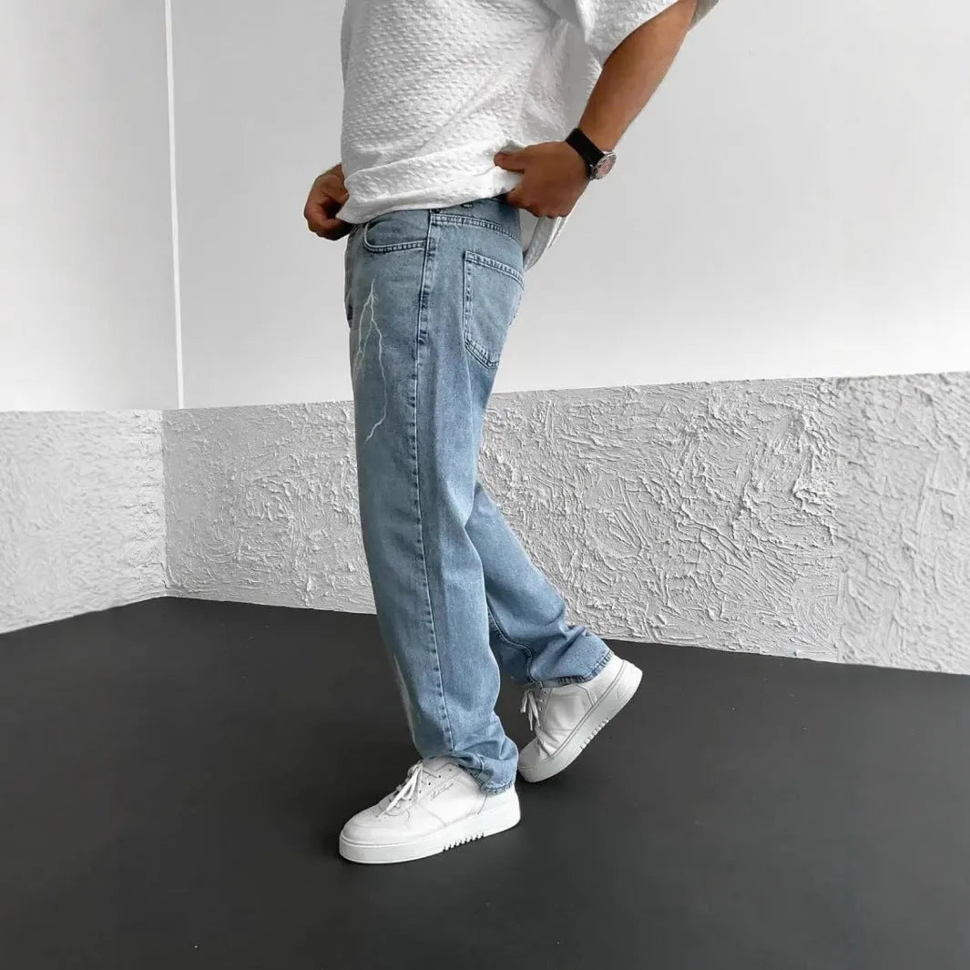 Men's blue straight-leg denim jeans with mid-waist design and loose wide-leg silhouette
