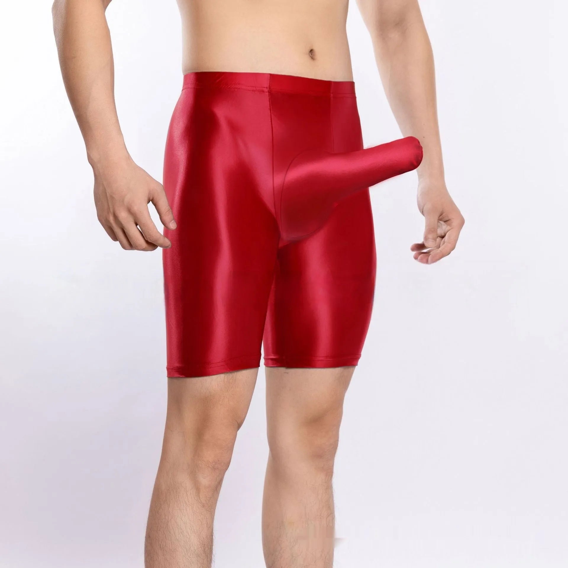 Man wearing shiny black plus size nylon sports shorts, showing silky finish.