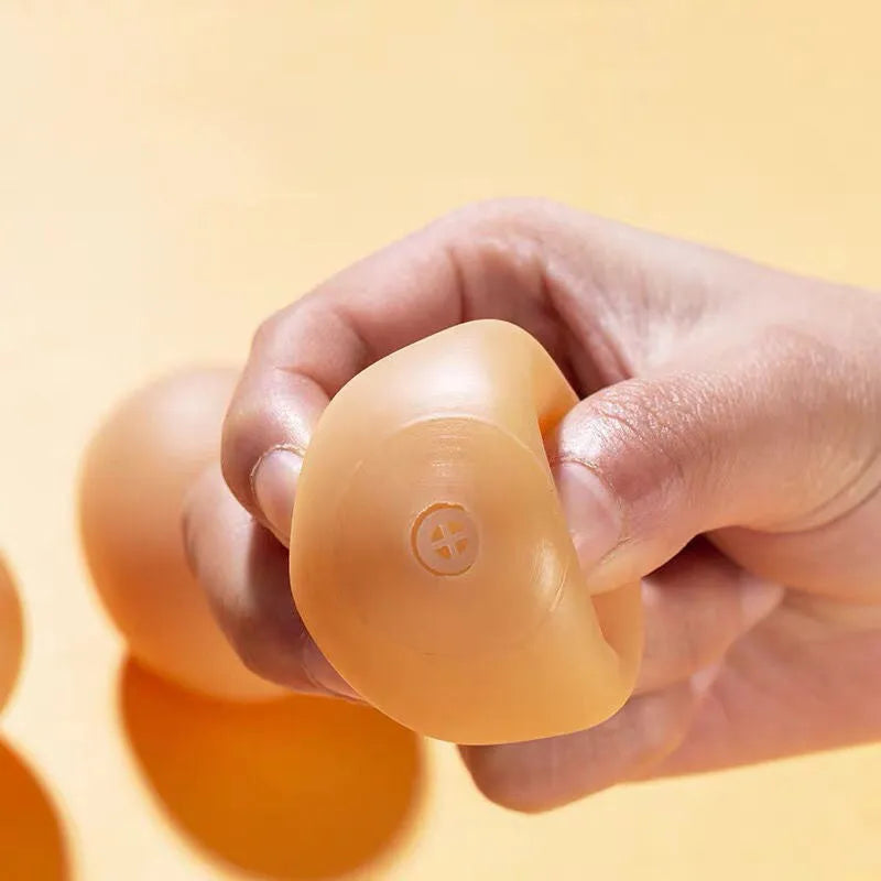 Egg-shaped dog toy with textured surface for tooth cleaning and sound feature