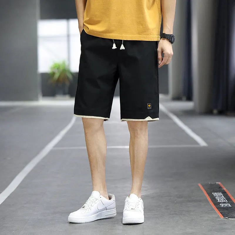 Man's loose-fitting straight-leg beach shorts in green on a neutral background.
