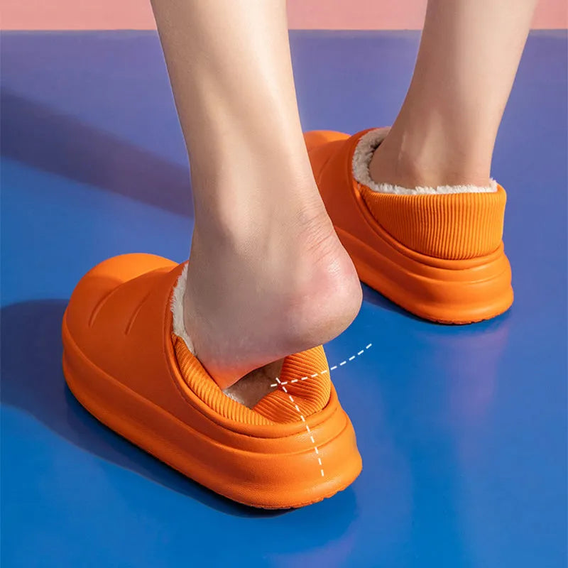 Yellow and green waterproof EVA winter house slippers with plush lining and non-slip sole.