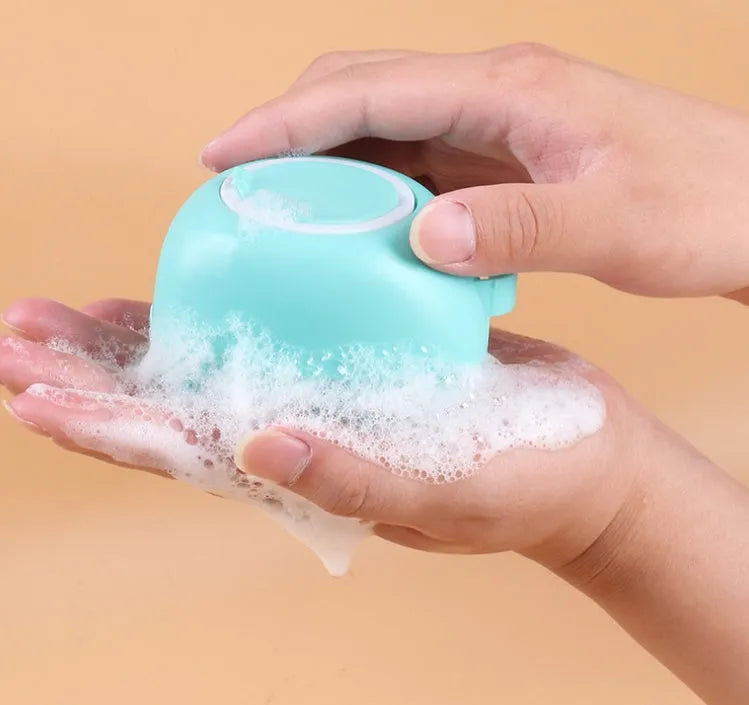 Blue silicone dog bath brush with handle for pet washing and massage during grooming