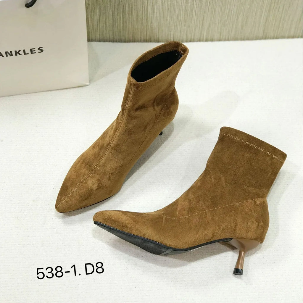 Black pointed toe ankle boots with stiletto heels and mid-calf length