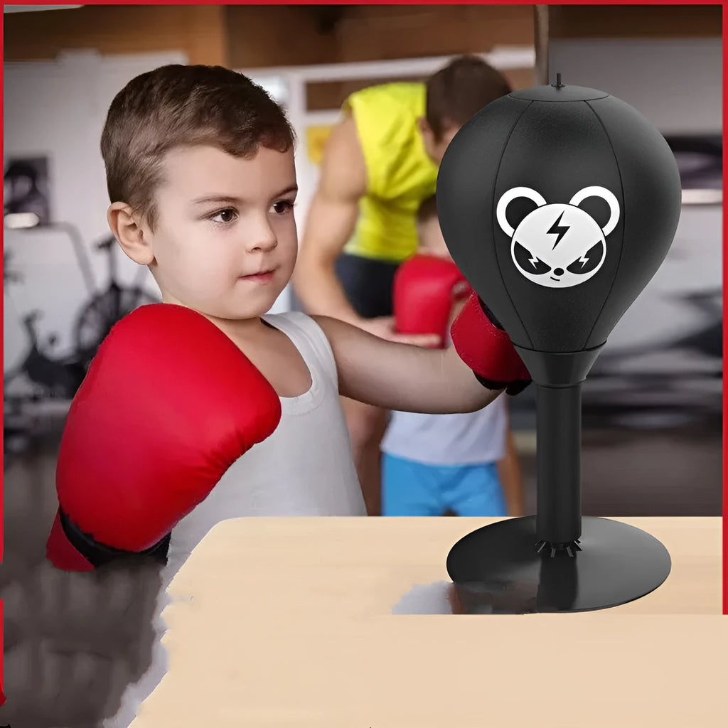 Tabletop boxing speed ball with suction cup base, inflatable PU leather sphere, and pump on a wooden desk.