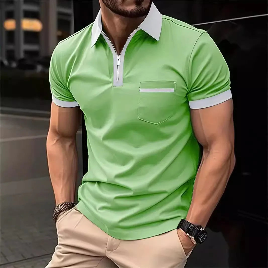Man wearing a grey and navy blue casual t-shirt with a chest pocket and silver zip decoration detail.