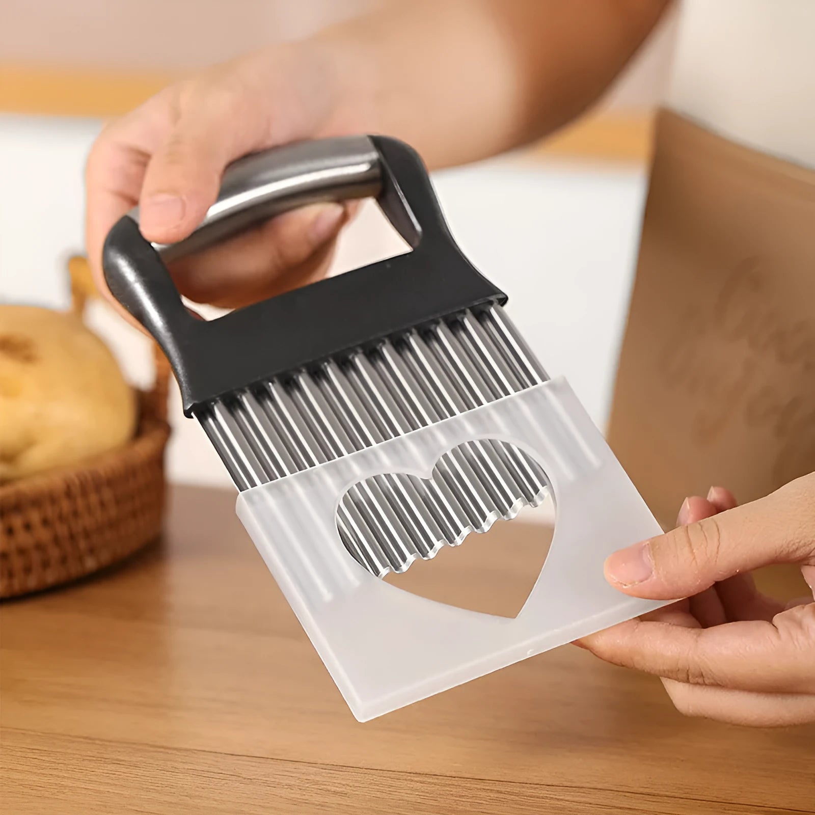 Stainless steel potato wave knife for cutting crinkle chips, shown in black colour.