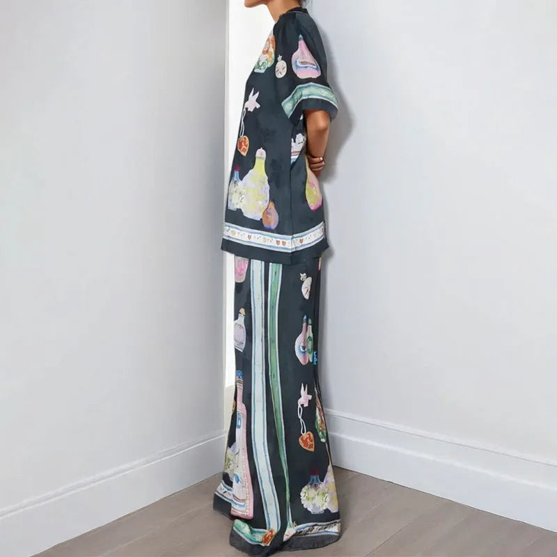 Black women's pyjama set with cartoon print pattern showing matching trousers and top