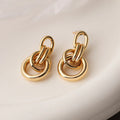 Women's gold geometric earrings with irregular shapes and high-profile metallic style