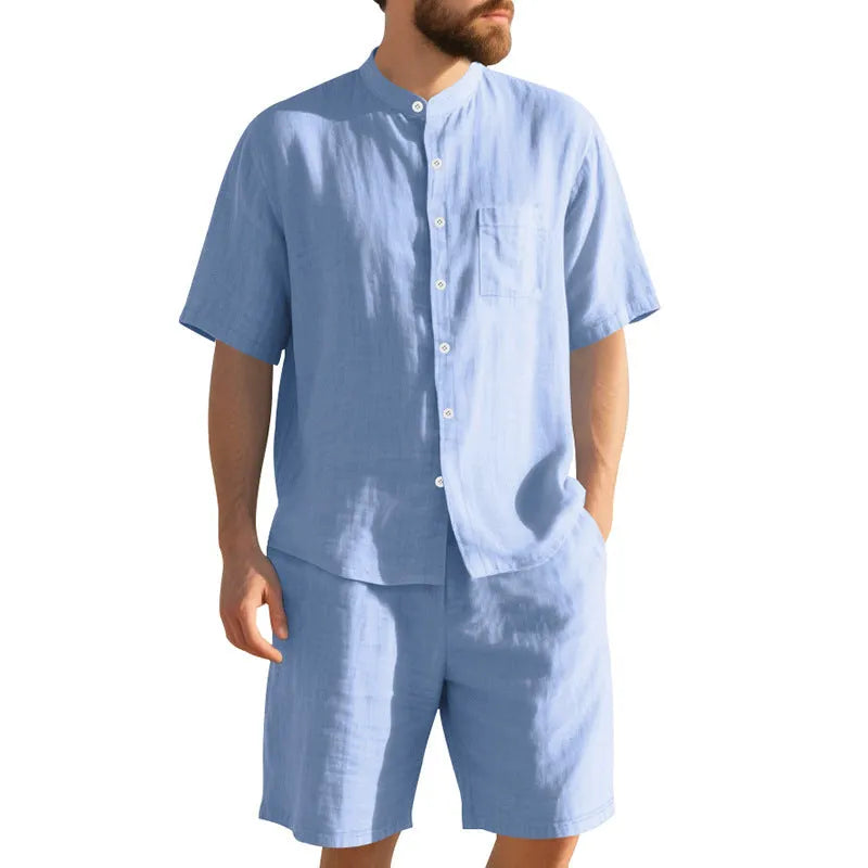Man wearing a light blue short-sleeve linen blend suit jacket and matching shorts with a Henry collar.