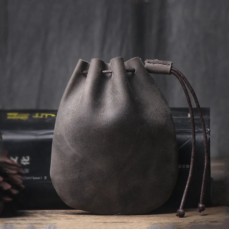 Vintage cowhide drawstring bundle wallet in chocolate brown showing sewing thread detail.