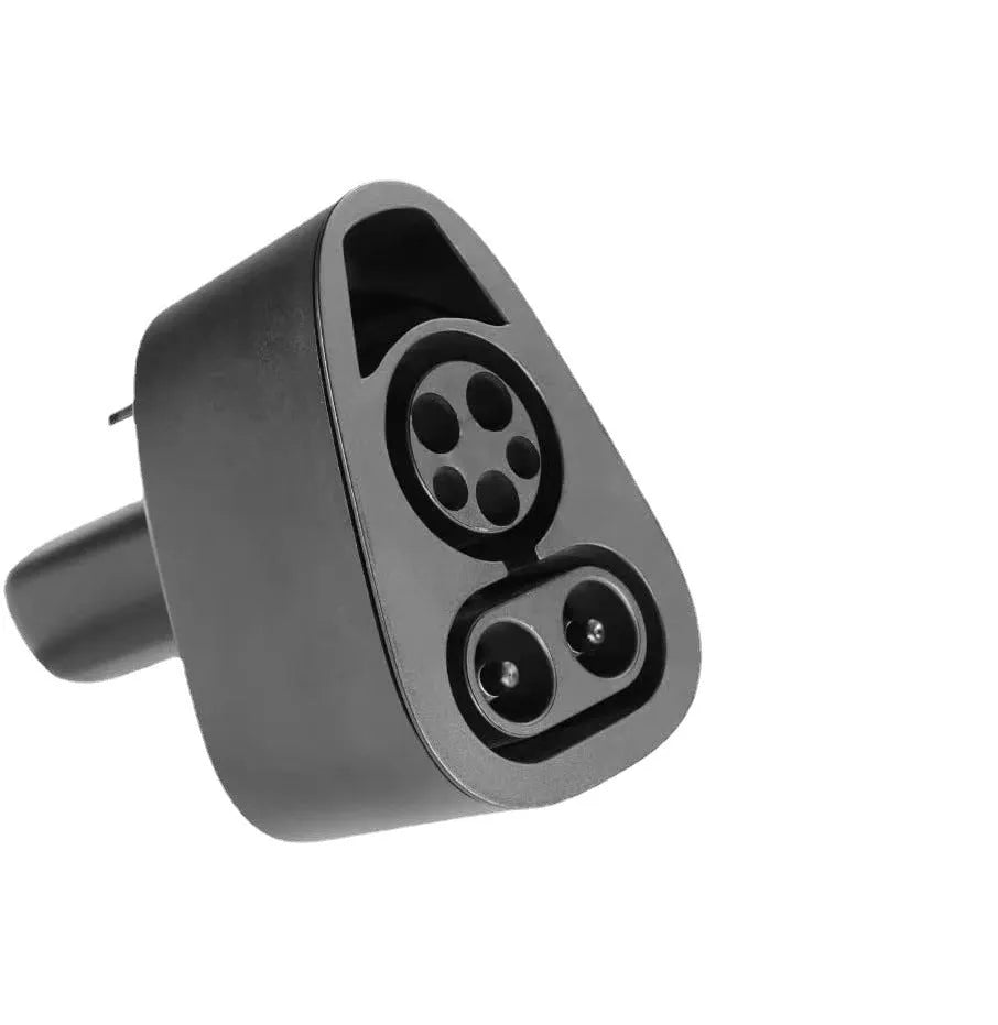 Black Tesla charging plug conversion adapter showing connection pins and dustproof housing