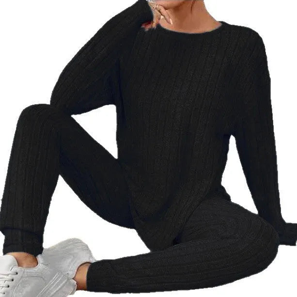 Women's black and blue sunken stripe patterned two-piece polyester homewear set with top and loose-fit pants.