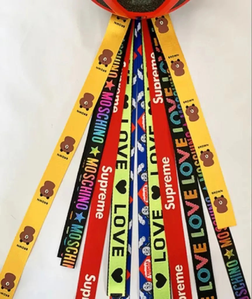A colourful helmet streamer accessory for children's sports helmets and doll decoration.