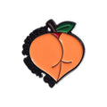 Colourful cartoon fruit design metal brooch with pin back on a fabric background.