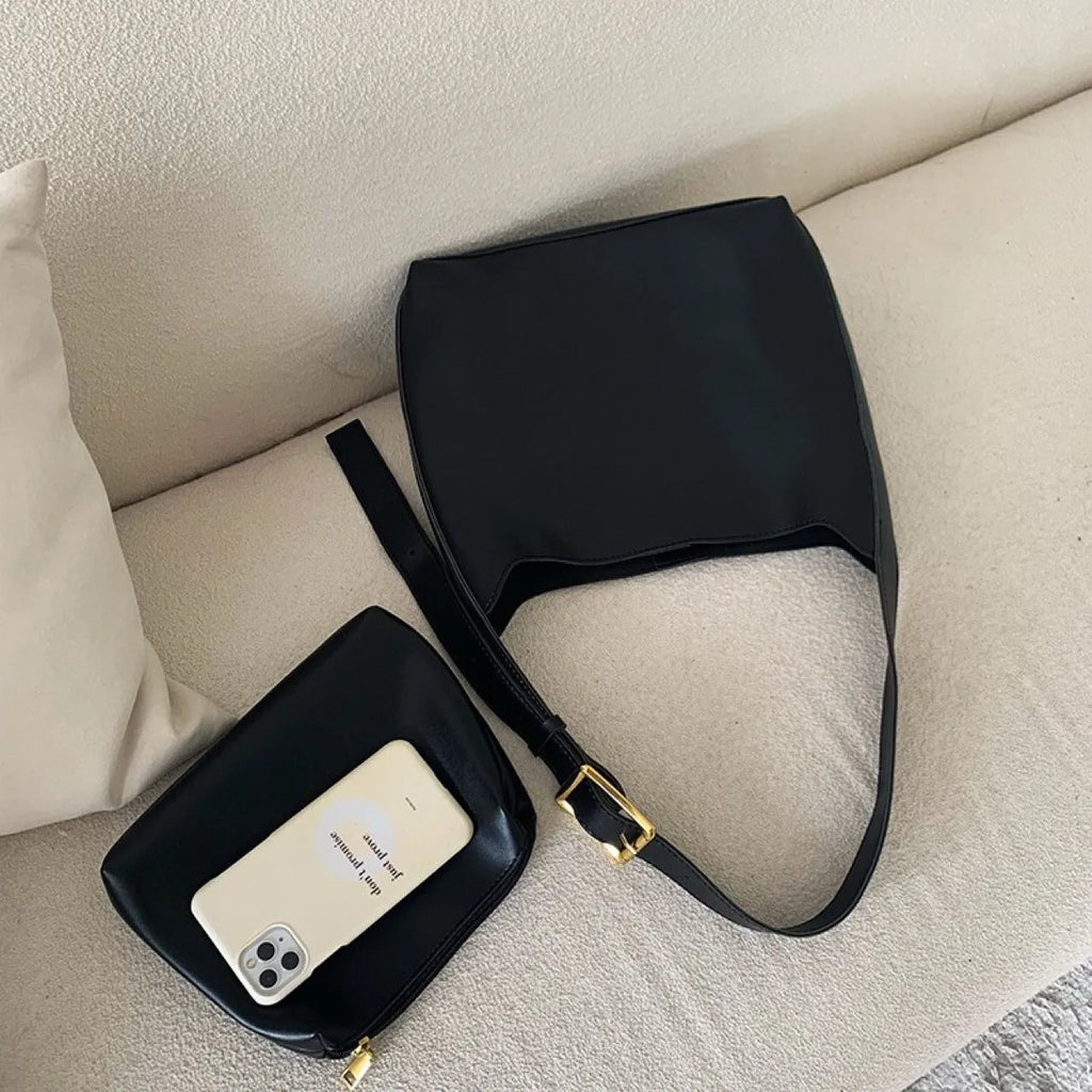 Women's soft PU leather shoulder bag with swing threads in black and brown colours showing ribbon and pocket detailing