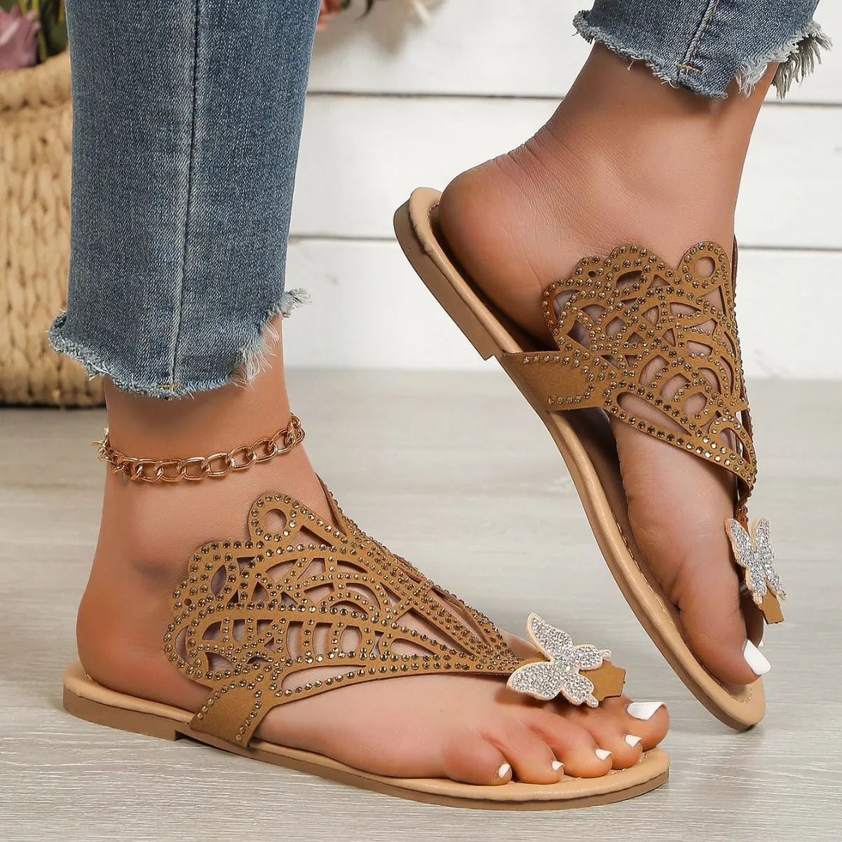 Women's black slip-on sandals with rhinestone decoration and flip-toe design.