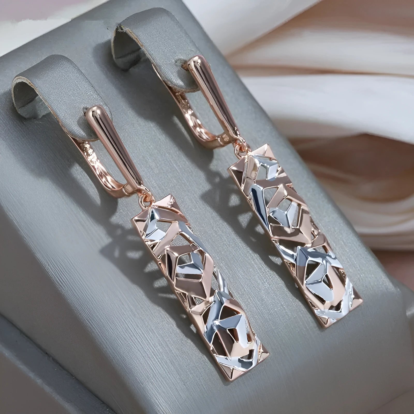 Two-tone rectangular hollow stud earrings for women, made from alloy with an electroplated finish.