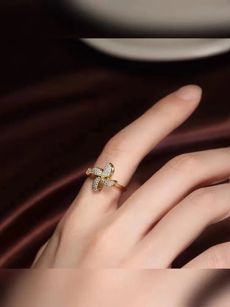 Copper spinning windmill ring with geometric shape, shown in gold and silver colour options.