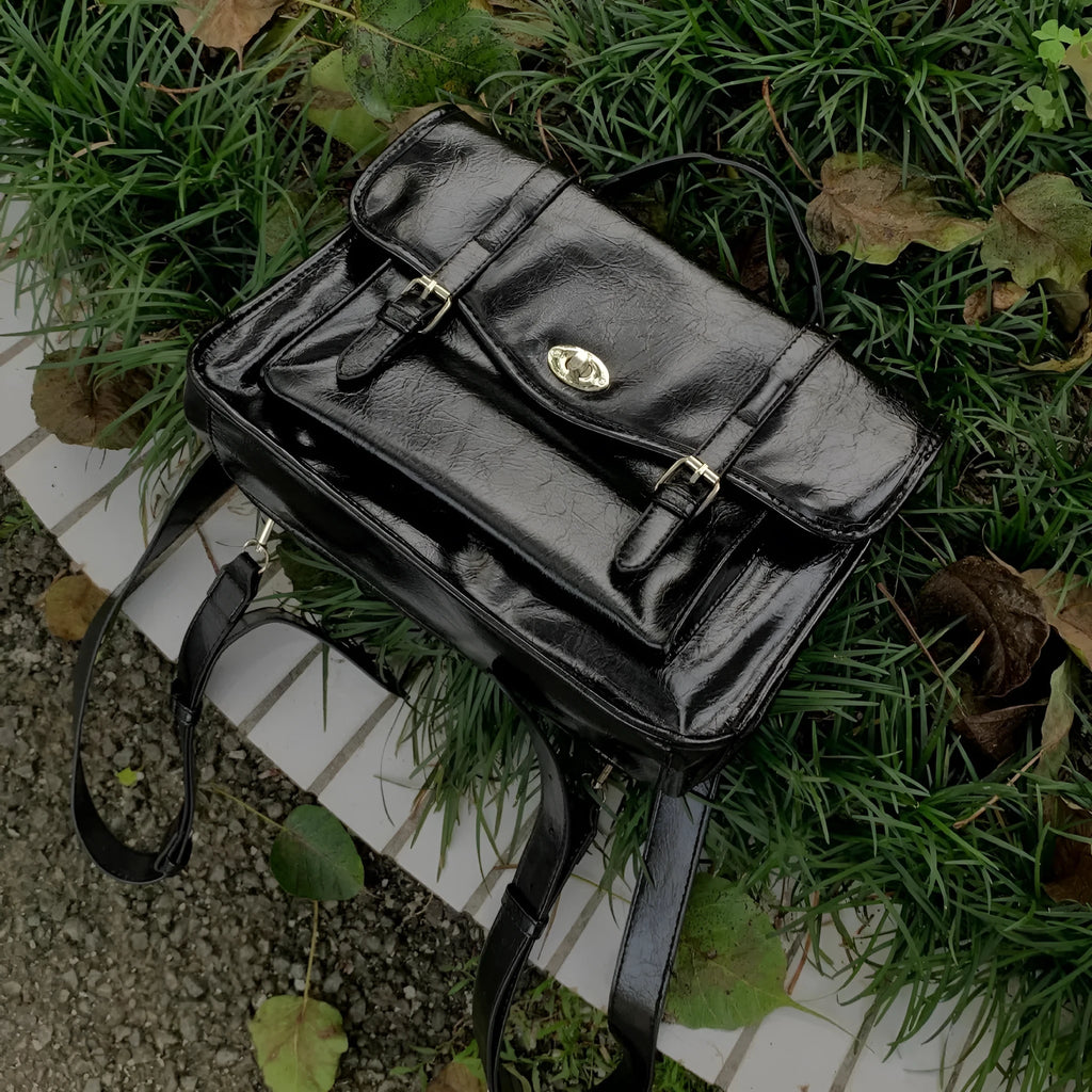 Black college style women's messenger bag with PU leather construction showing dimensions