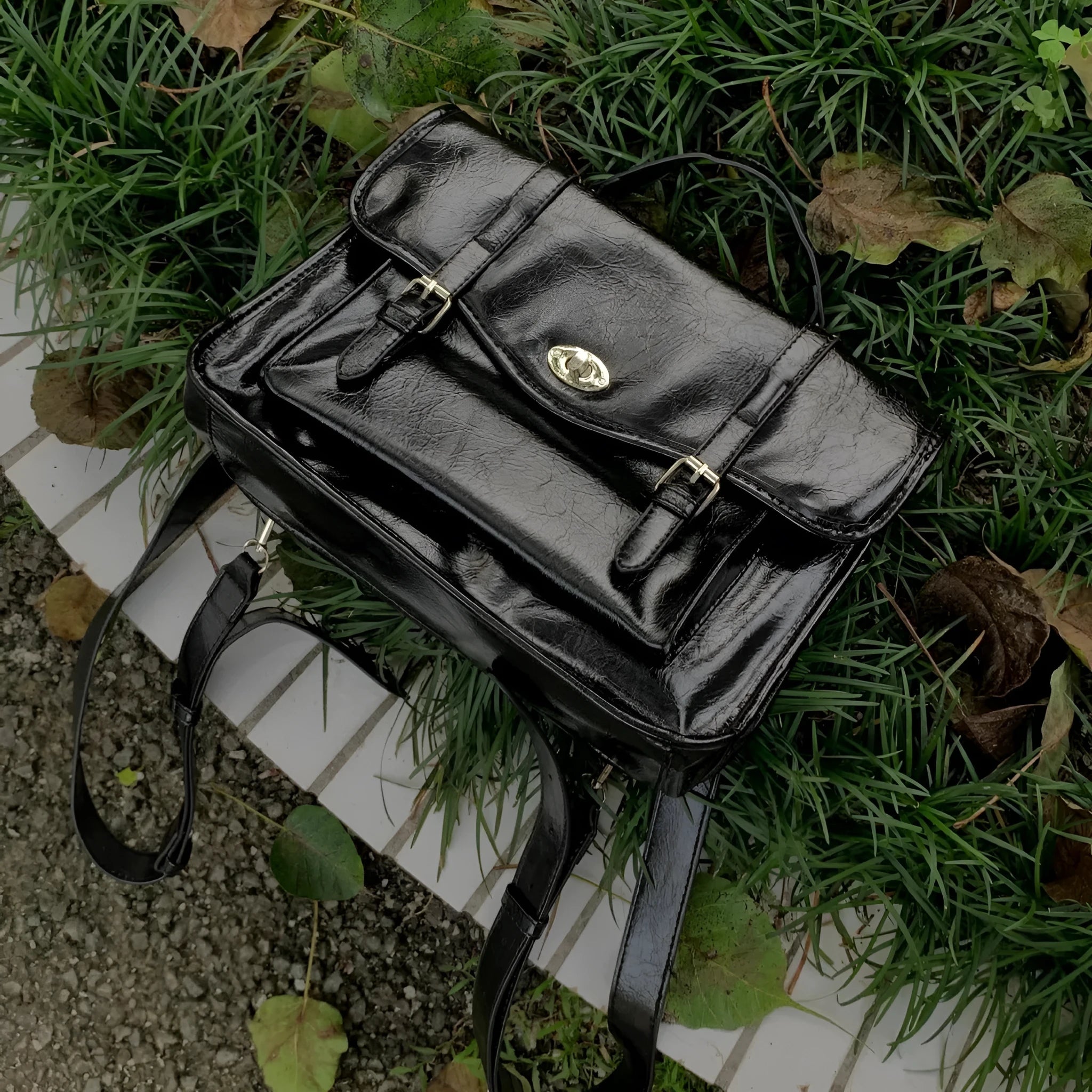 Black college style women's messenger bag with PU leather construction showing dimensions