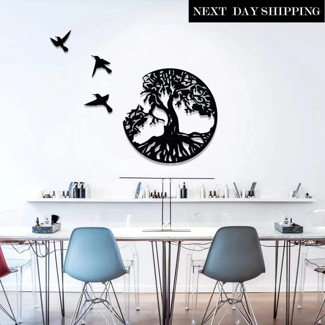 Black iron wind chime wall art hanging on a wall in a modern simple style.
